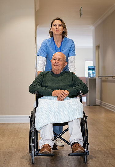 Nurse-helping-old-man-in-wheelchair photo